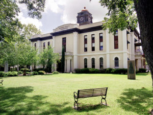 courthouse in bastrop texas with lawn and mature trees