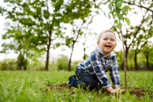 young boy with new tree planting